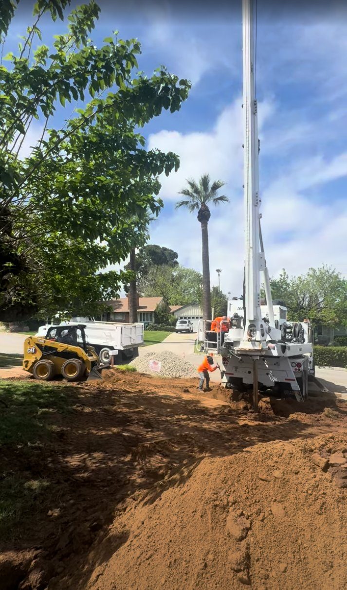 Drill rig setting up for a deep seepage pit in a neighborhood